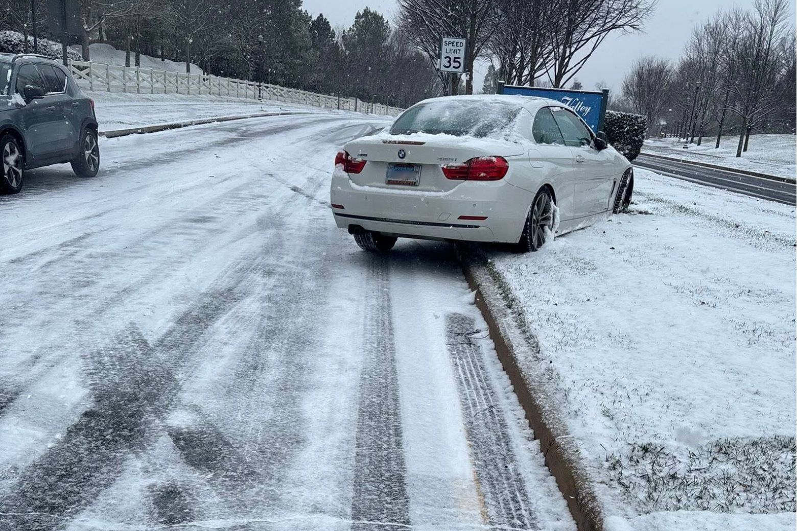 A car appears to be stopped on a snowy median, facing the wrong direction, in Haymarket, Virginia, on Dec. 5, 2025.