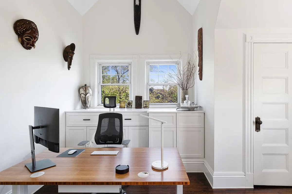 family room with corner office set-up with white cabinets