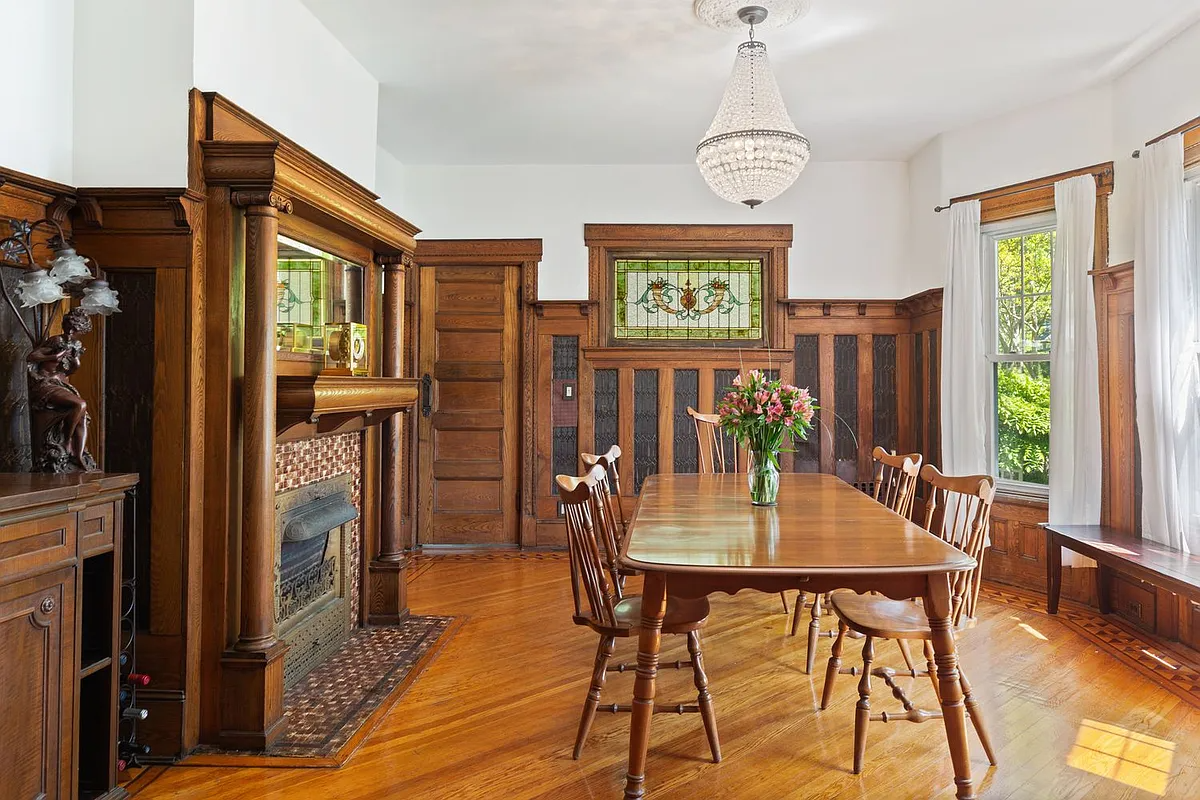 dining room with mantel, wainscoting, stained glass