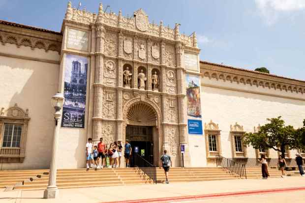 A group of people walk out of the San Diego Museum of Art in Balboa Park in San Diego on Nov. 11, 2025. (Brittany Cruz-Fejeran / The San Diego Union-Tribune)