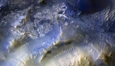image from mars orbit showing rugged desert mountain terrain on the red planet