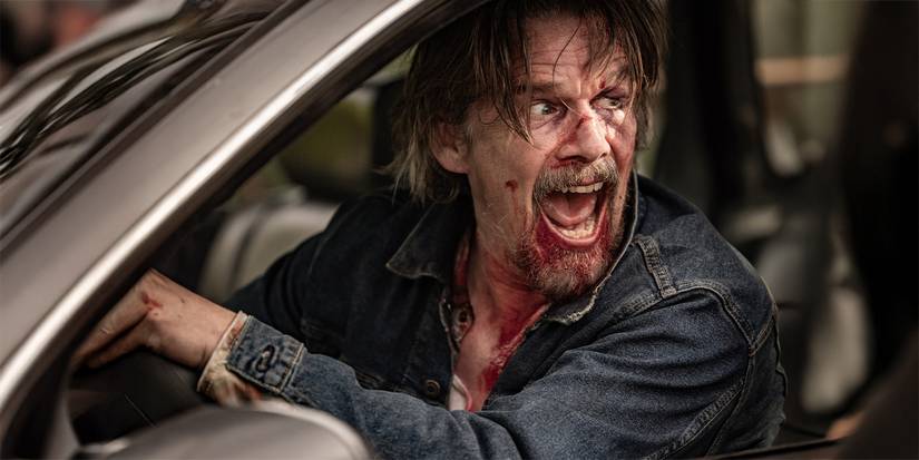Lee Raybon (Ethan Hawke), with a bloody face, at the wheel of a car in 'The Lowdown'