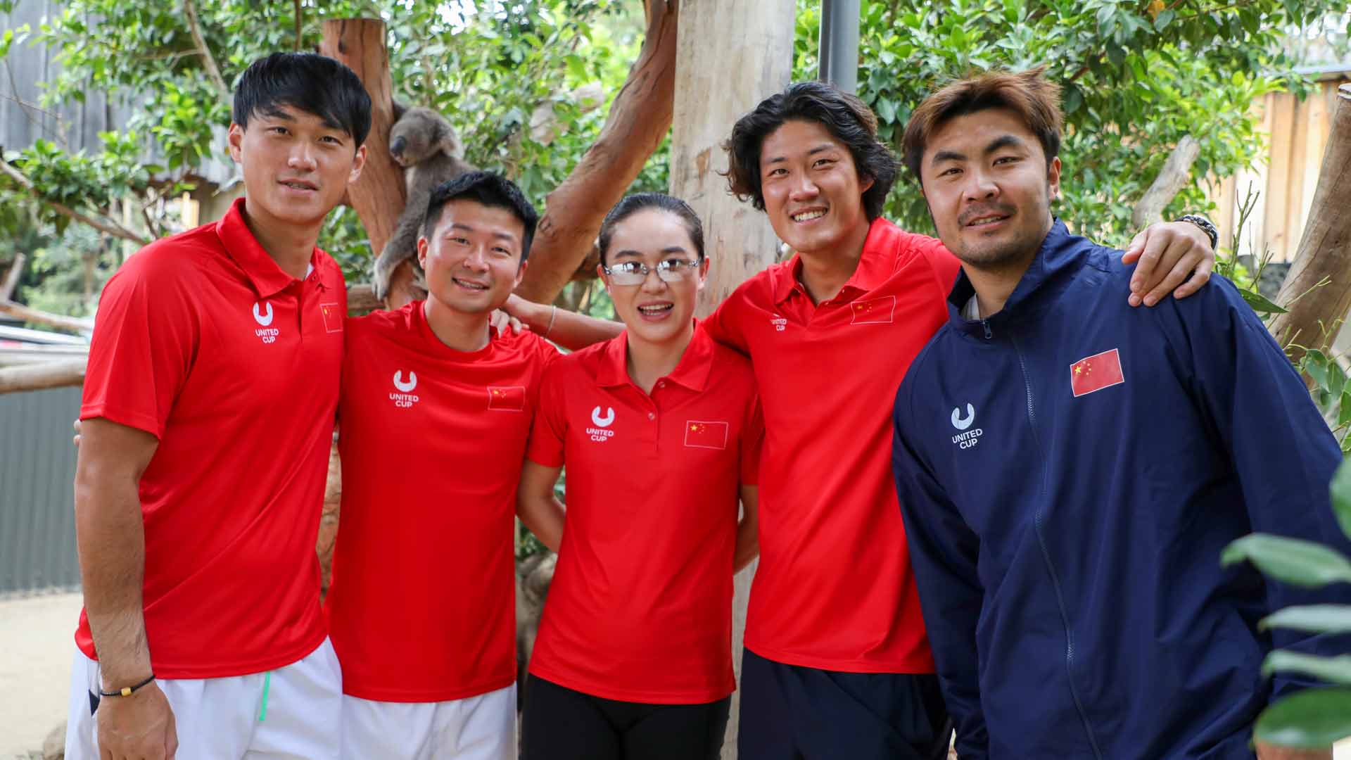 Team China with a koala at the Sydney Zoo.
