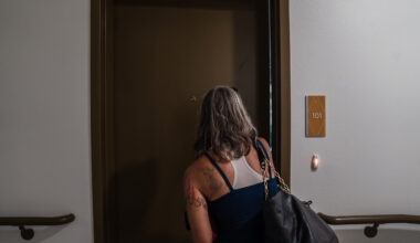 Rachel Hayes brings some of her belongings inside her apartment at Milejo Village in San Ysidro on June 20, 2023. The apartment building is a 65-unit supportive housing community by Jamboree Housing Corporation.