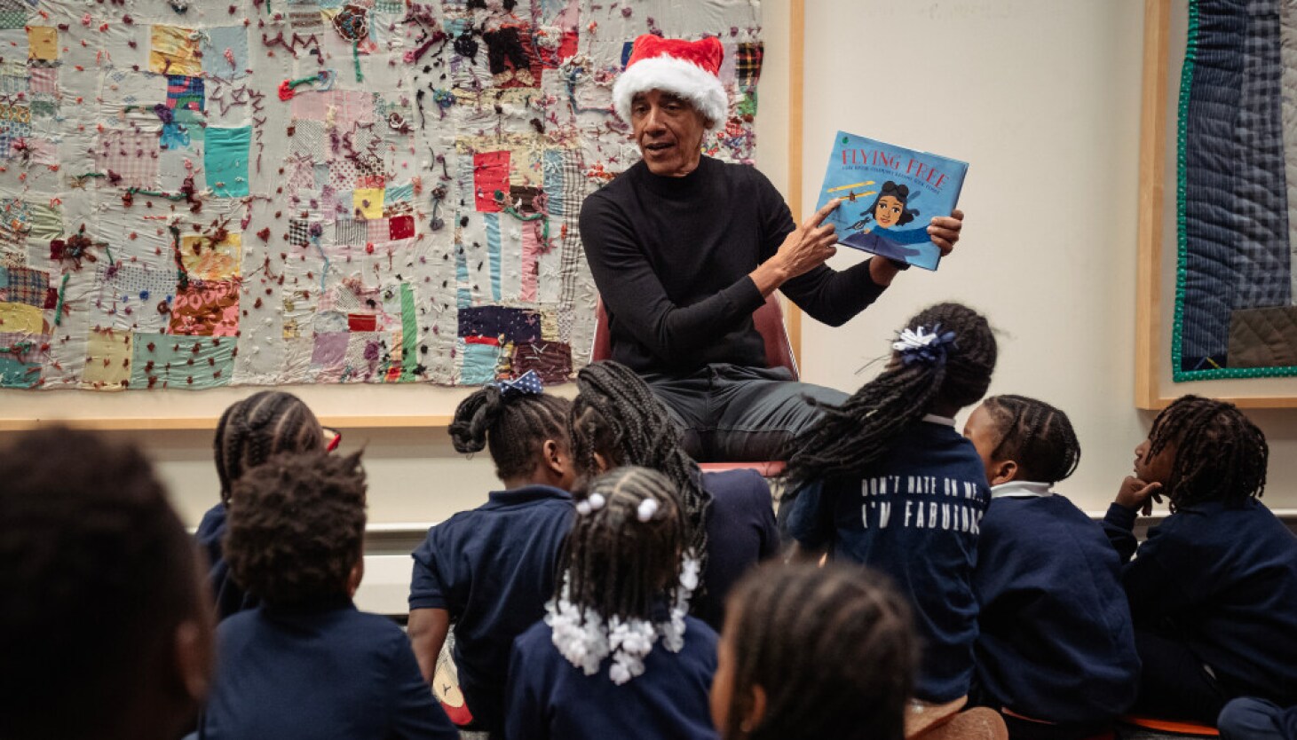 Barack Obama in Santa hat surprises school children during visit to Chicago