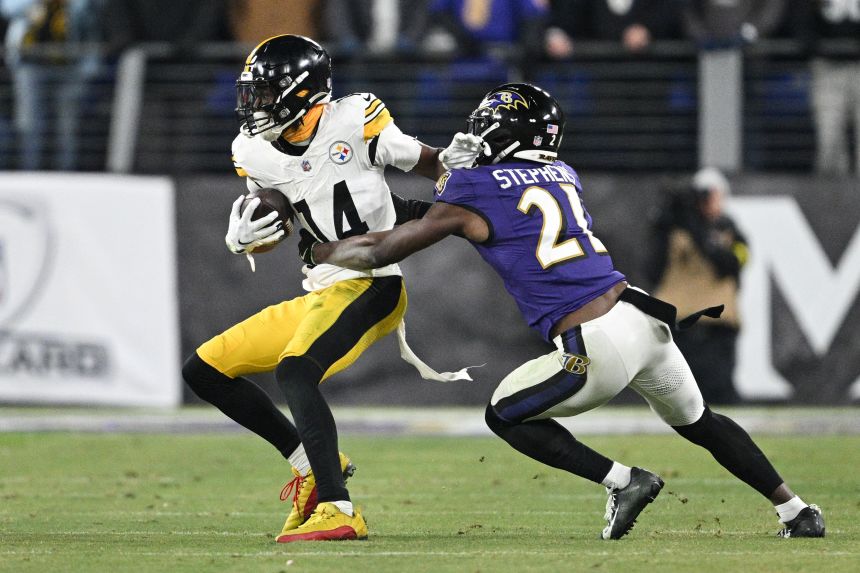 Pittsburgh Steelers wide receiver George Pickens fighting off Baltimore Ravens cornerback Brandon Stephens in the AFC wild card game on January 11.