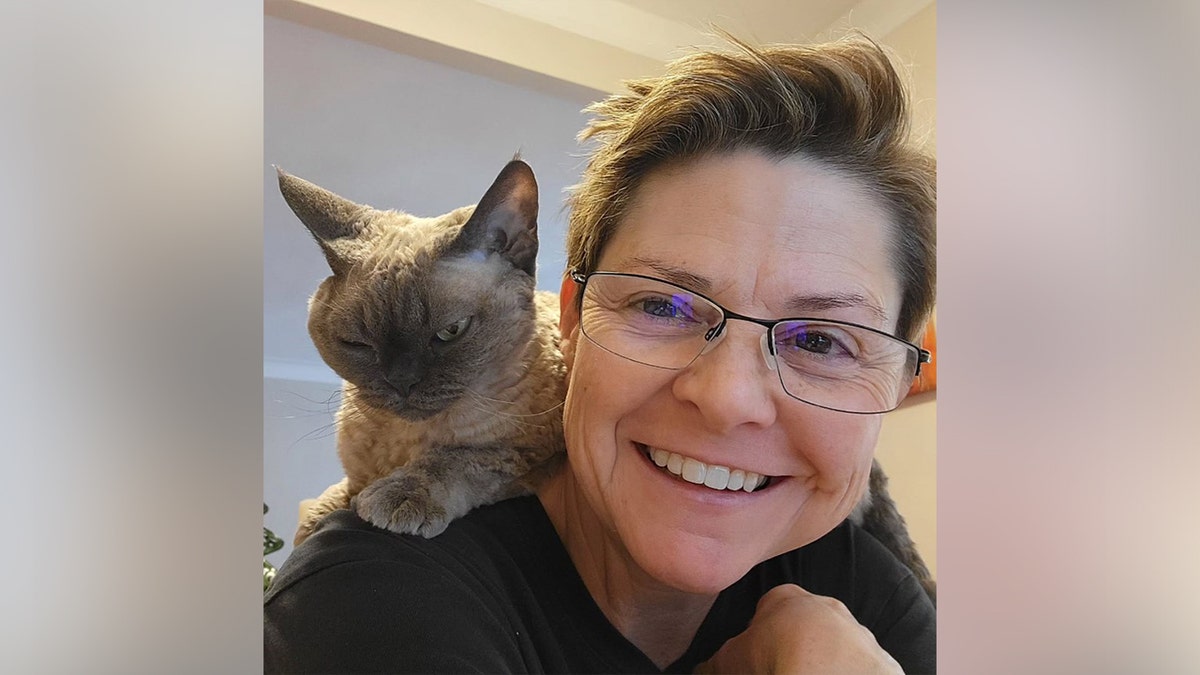 Wenne Alton Davis with her cat on her shoulder.