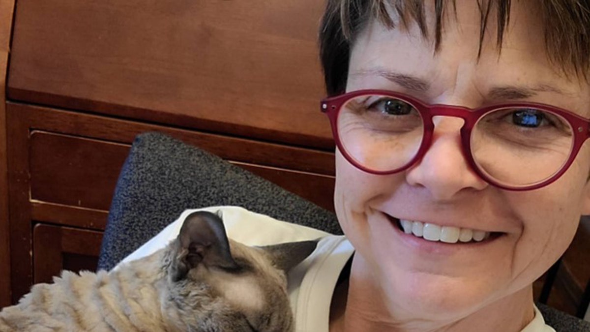 Wenne Alton Davis cuddling with her cat.