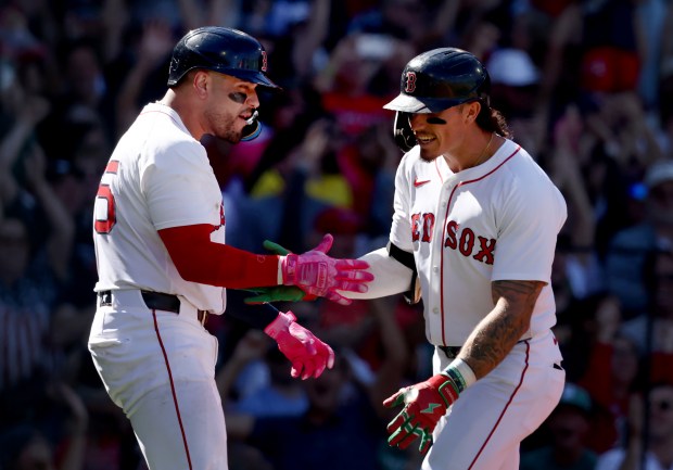 Boston Red Sox's Jarren Duran, right, celebrates with Carlos Narváez after his inside-the-park home run during an Aug. 31 game at Fenway Park. (Nancy Lane/Boston Herald)