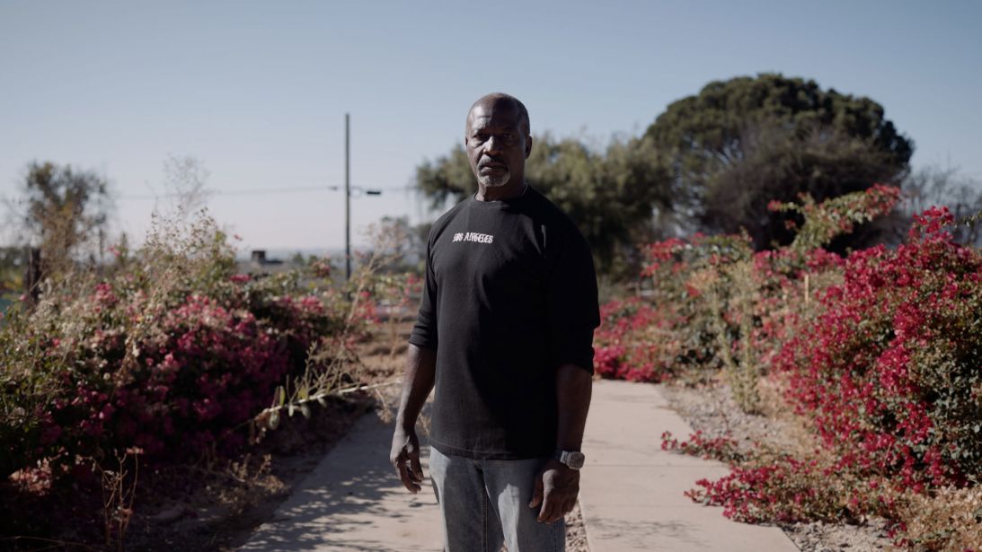 Troy Laster stands near the burned-out Altadena lot where his home once stood. He sold the property to a developer and moved to Las Vegas.