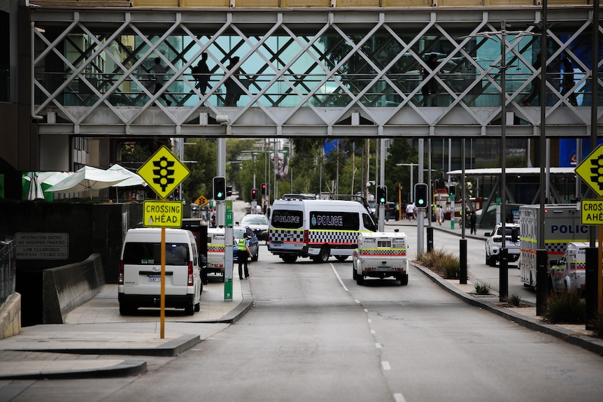 Police vehicles are setting road blocks for a rally to march 