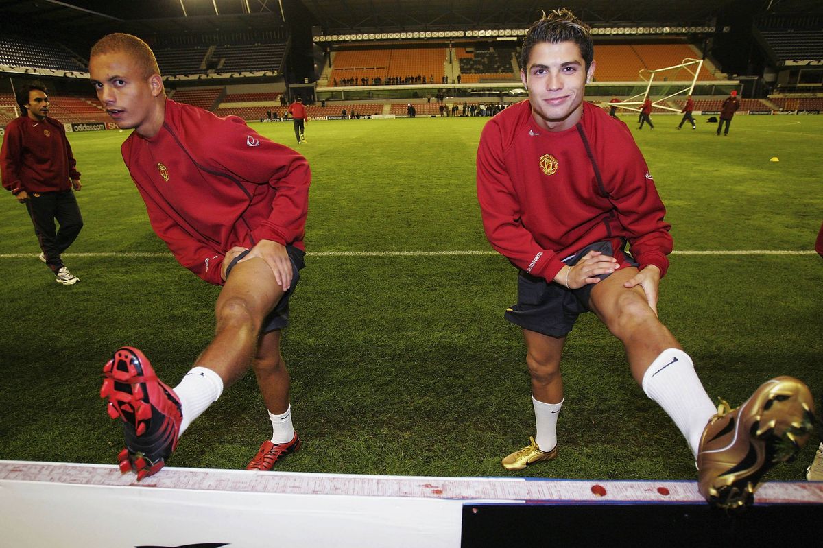 Wes Brown (L) and Cristiano Ronaldo of Manchester United warm up during a training session ahead of the UEFA Champions League match between Sparta Prague and Manchester United