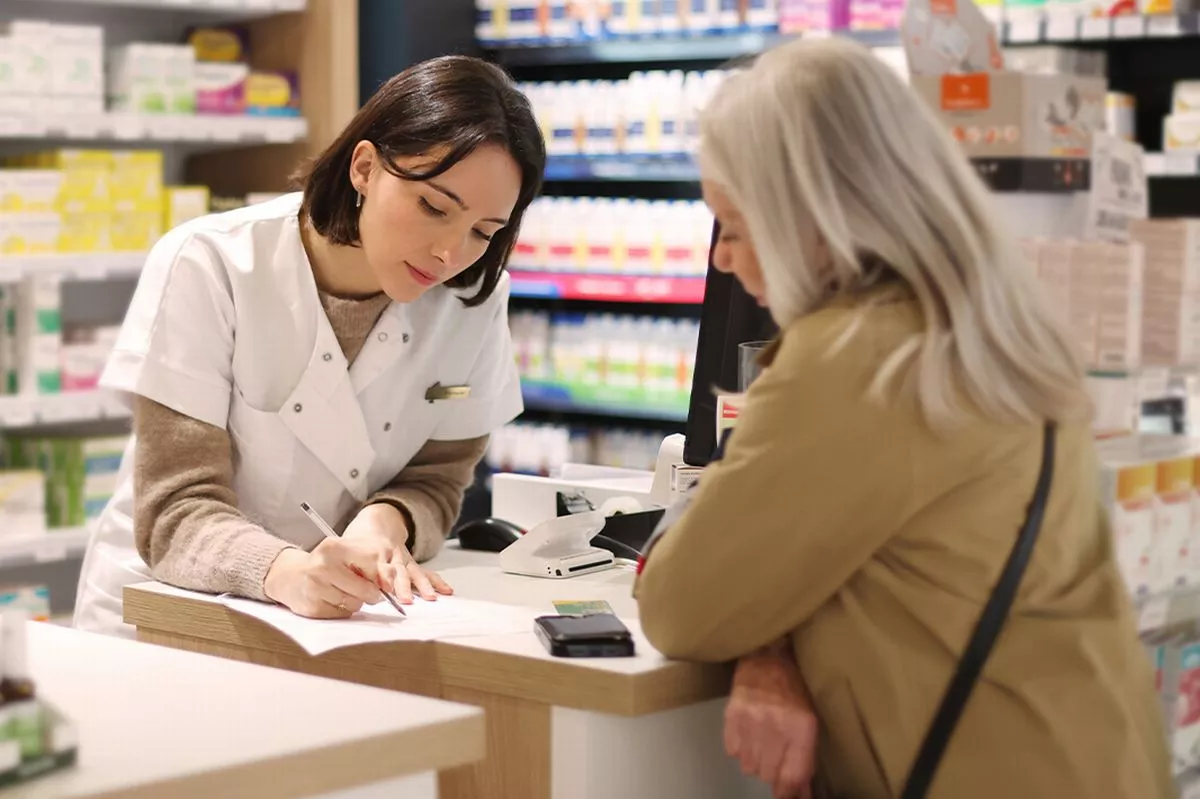 A woman picking up a prescription