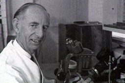 A scientist with a microscope.