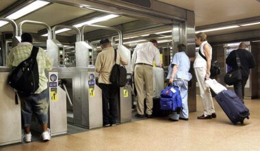 Travelers go through CTA turnstiles