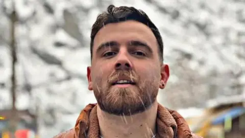 Hengaw Organization for Human Rights Image of Erfan Soltani, he has a beard and short brown hair. 