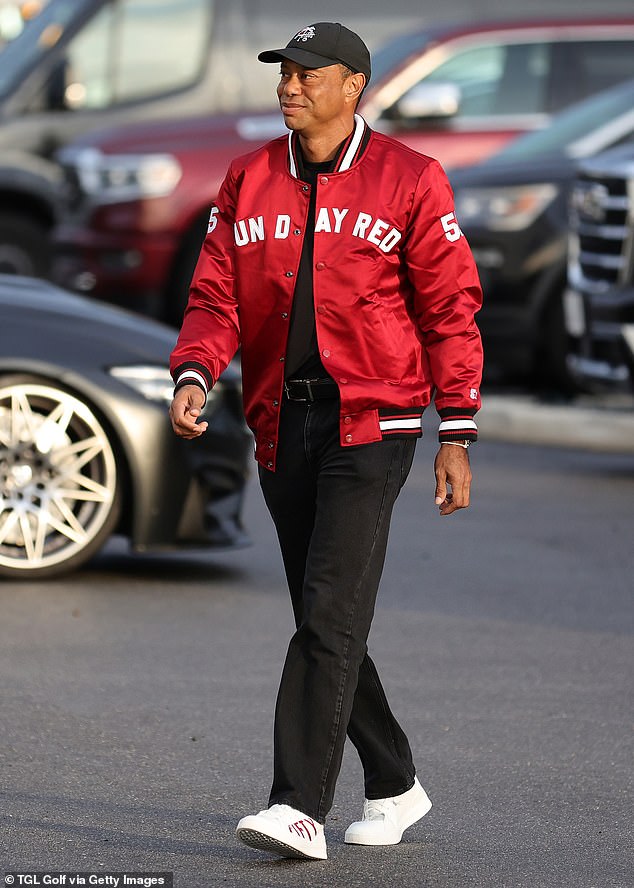 The 15-time major winner is pictured arriving to a TGL match in a Sun Day Red bomber jacket