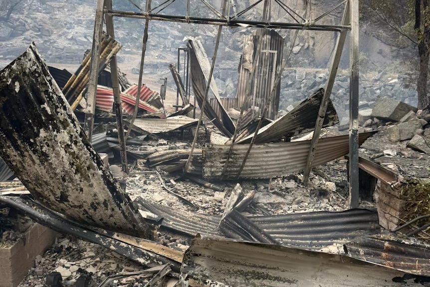 the remains of tin and wood structure burnt out by fire 