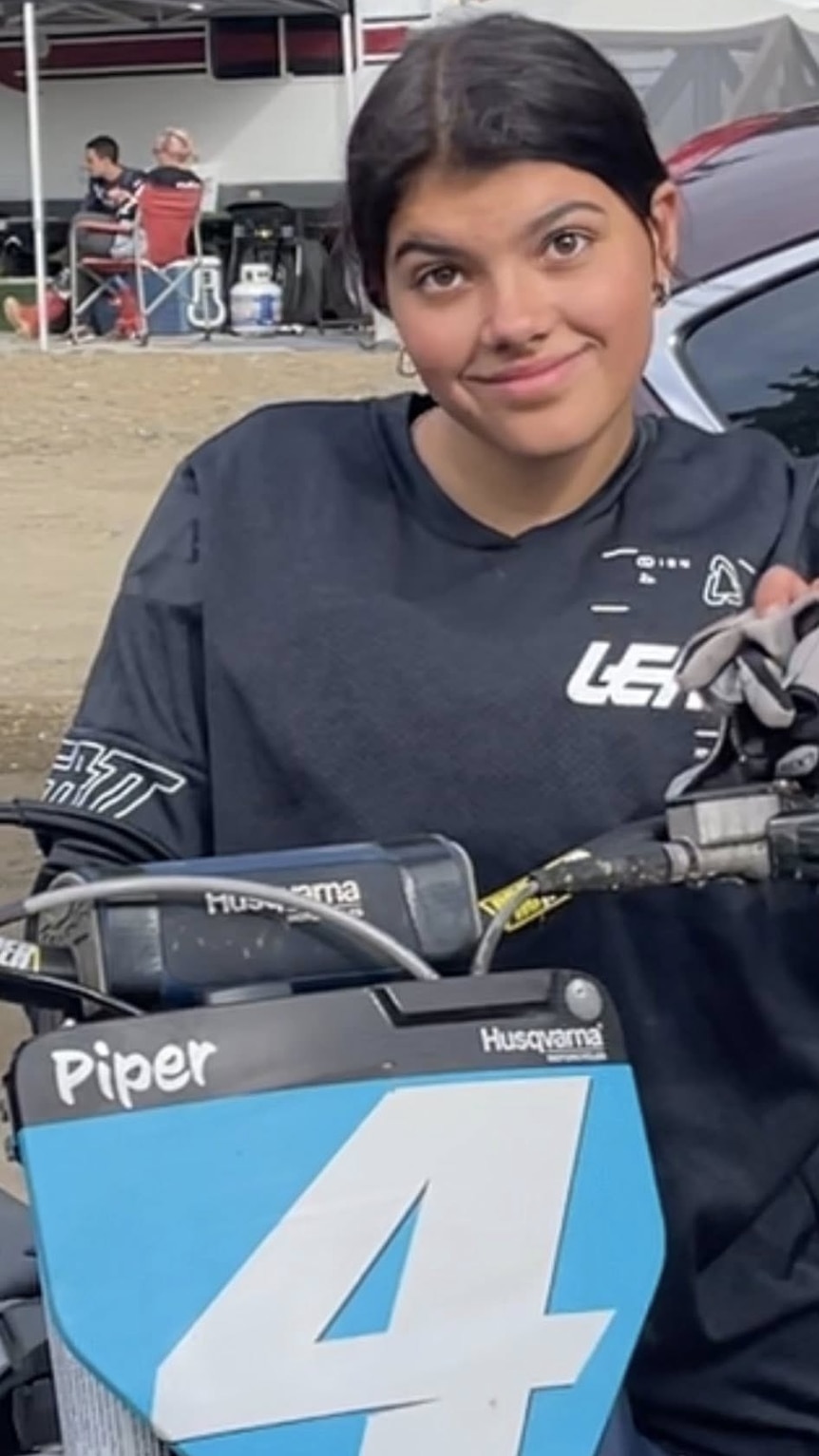A young woman on a dirt bike