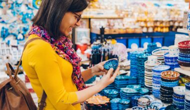 Woman dressed in bright colors, holding a small bowl, shopping in bazaar market, Istanbul stock photo