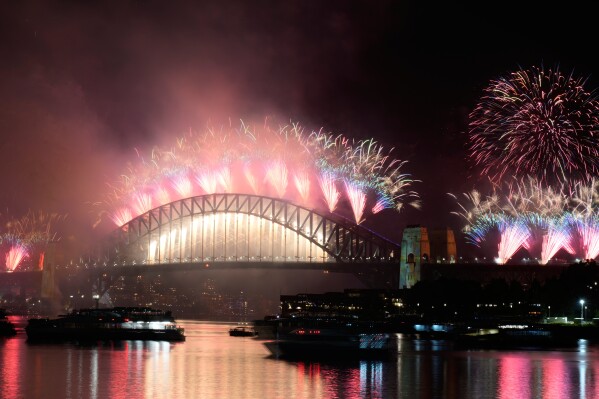 Fireworks burst over the Sydney Harbour Bridge during the New Year celebrations in Sydney, Thursday, Jan. 1, 2026. (AP Photo/Rick Rycroft)