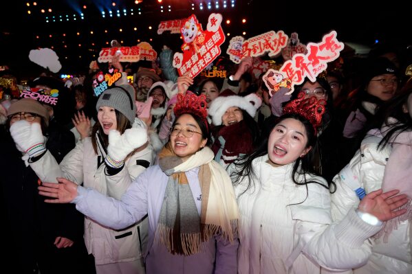 Revelers ring in the new year at the Juyongguan Great Wall on the outskirts of Beijing, China, early Thursday, Jan. 1, 2026. (AP Photo/Ng Han Guan)