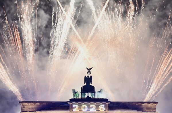 Fireworks can be seen above the Brandenburg Gate at the "Yeah 26" New Year's Eve event, in Berlin, Thursday, Jan. 1, 2026. (Britta Pedersen/dpa via AP)