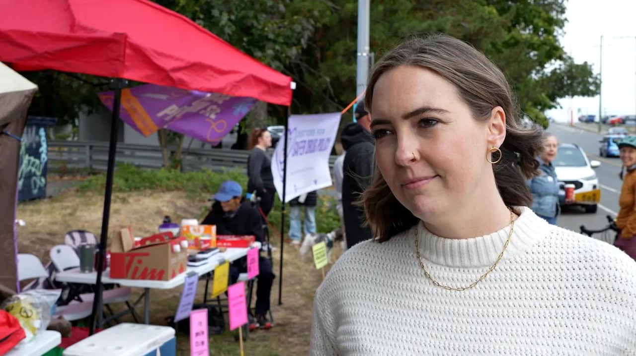 A woman speaks to a camera