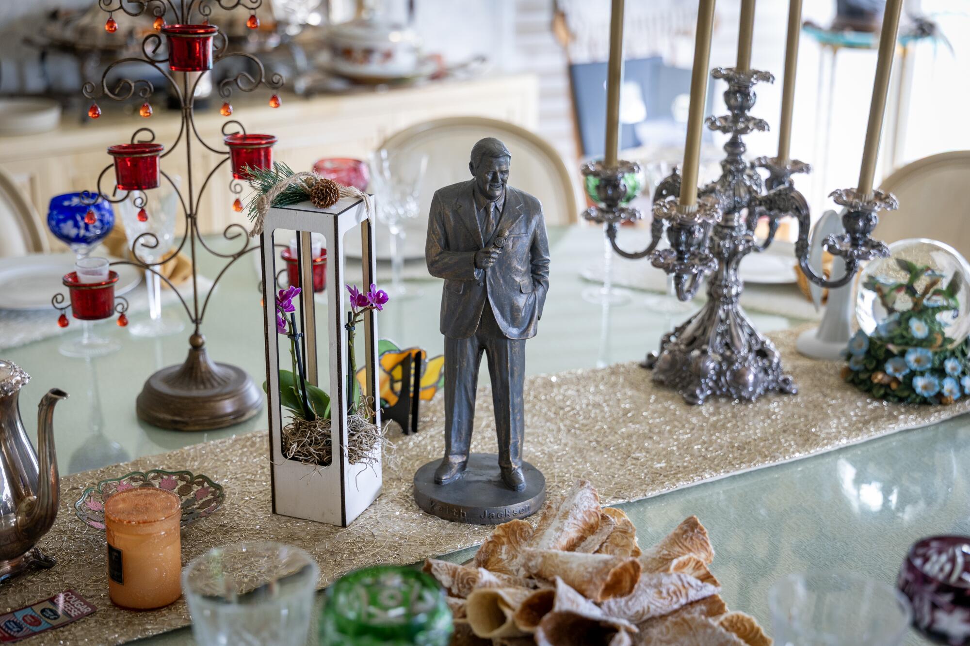 A miniature version of the Keith Jackson statue that stands outside the Rose Bow Stadium.