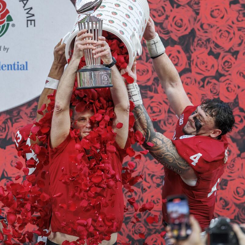 Indiana coach Curt Cignetti is showered in rose petals as he lifts the Leishman Trophy after the Hoosiers' win.