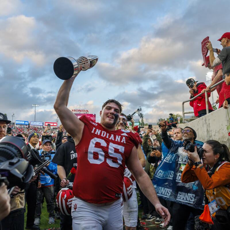 Indiana offensive lineman Carter Smith celebrates while lifting the Rose Bowl trophy.