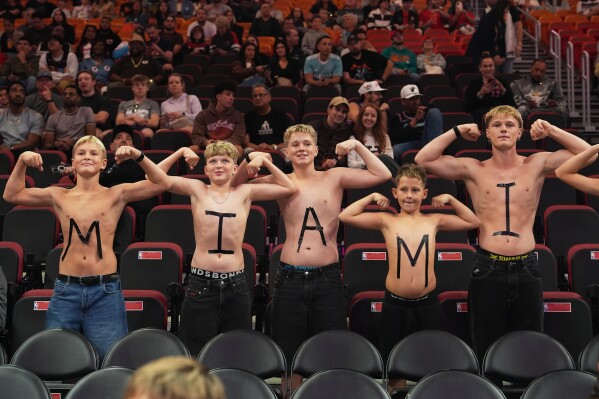 Fans pose for a photo before an NBA basketball game between the Miami Heat and the Indiana Pacers, Dec. 27, 2025, in Miami. (AP Photo/Lynne Sladky, File