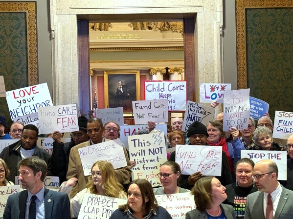 People gather for a news conference at the state capitol in St. Paul, Minn., on Wednesday, Dec. 31, 2025. (AP Giovanna Dell'Orto)