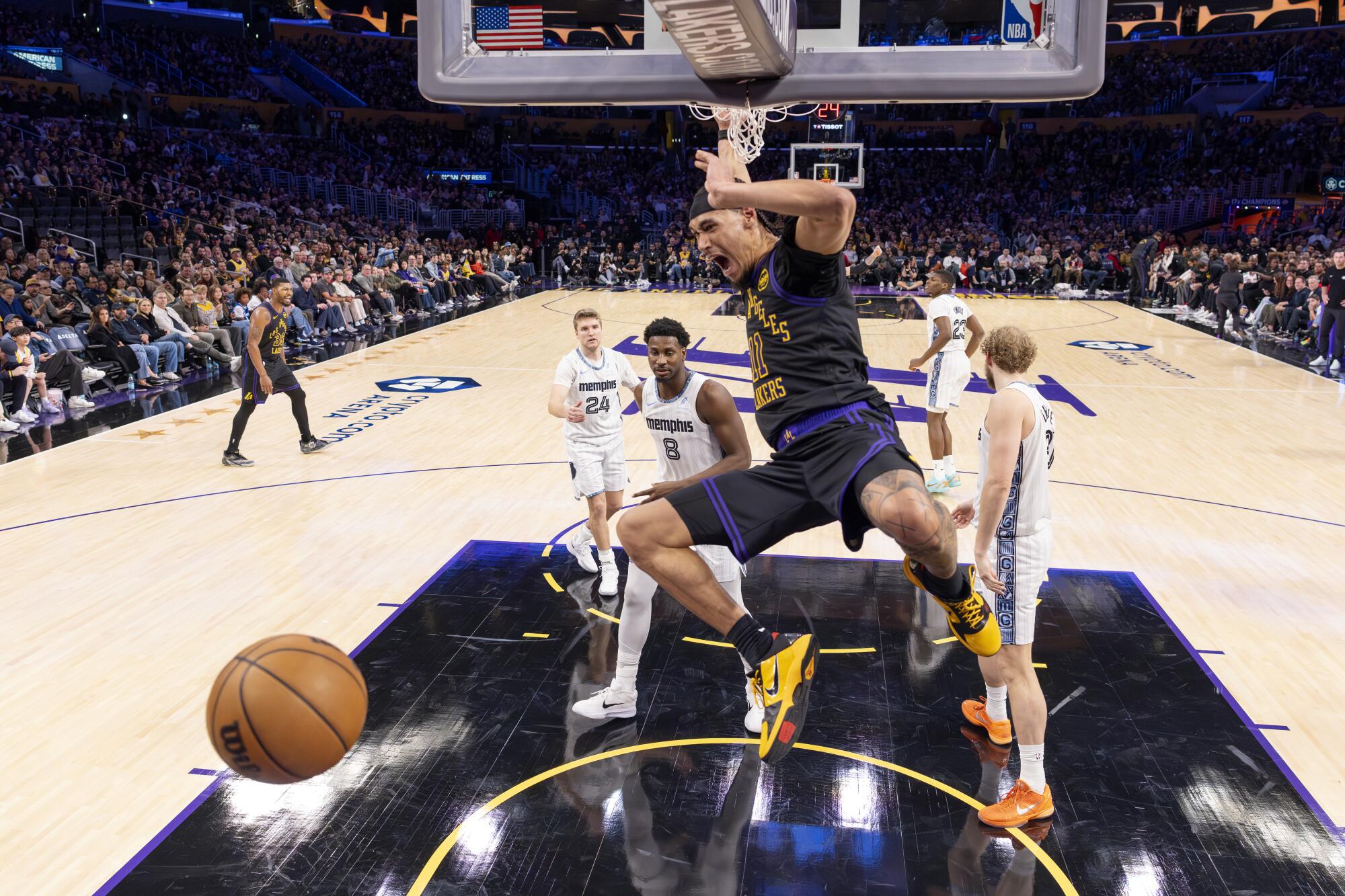 Lakers center Jaxson Hayes yells as he dunks in front of Grizzlies forward Jaren Jackson Jr. and center Jock Landale.