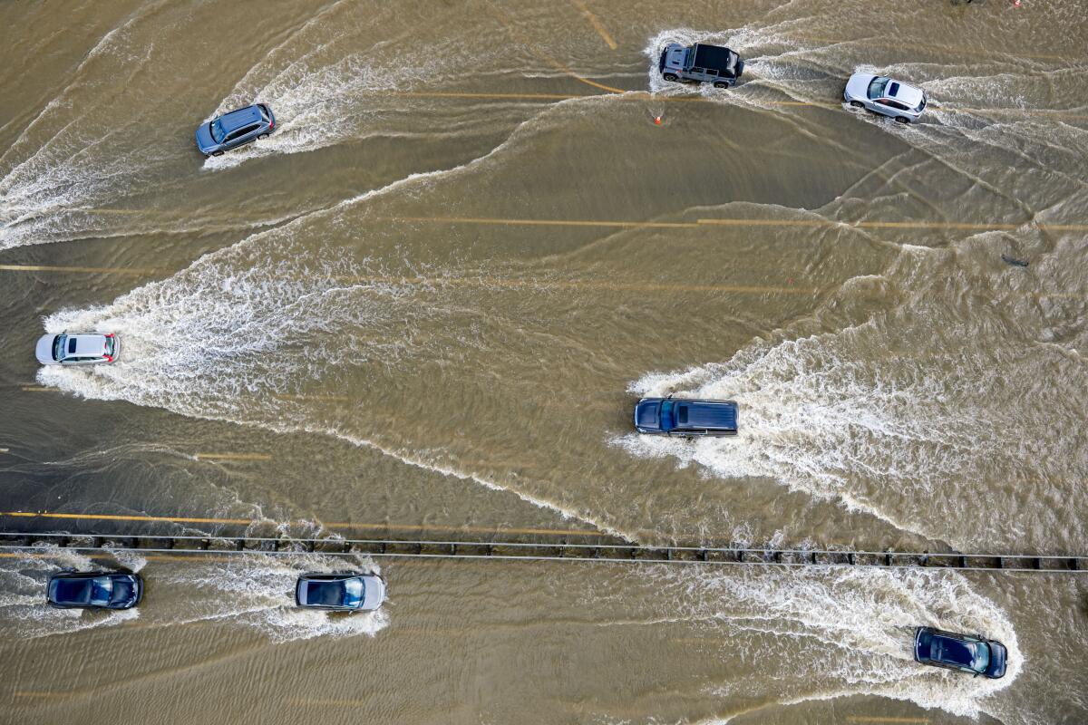Cars drive on highway 101 flooded by the "King Tides."