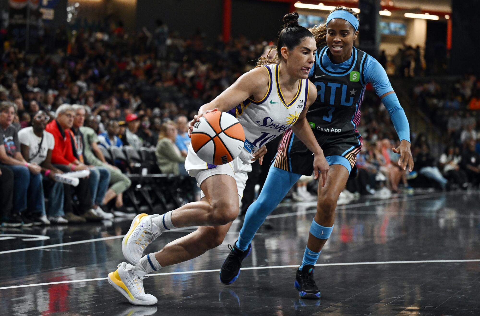 Sparks guard Kelsey Plum drives against Dream guard Jordin Canada.