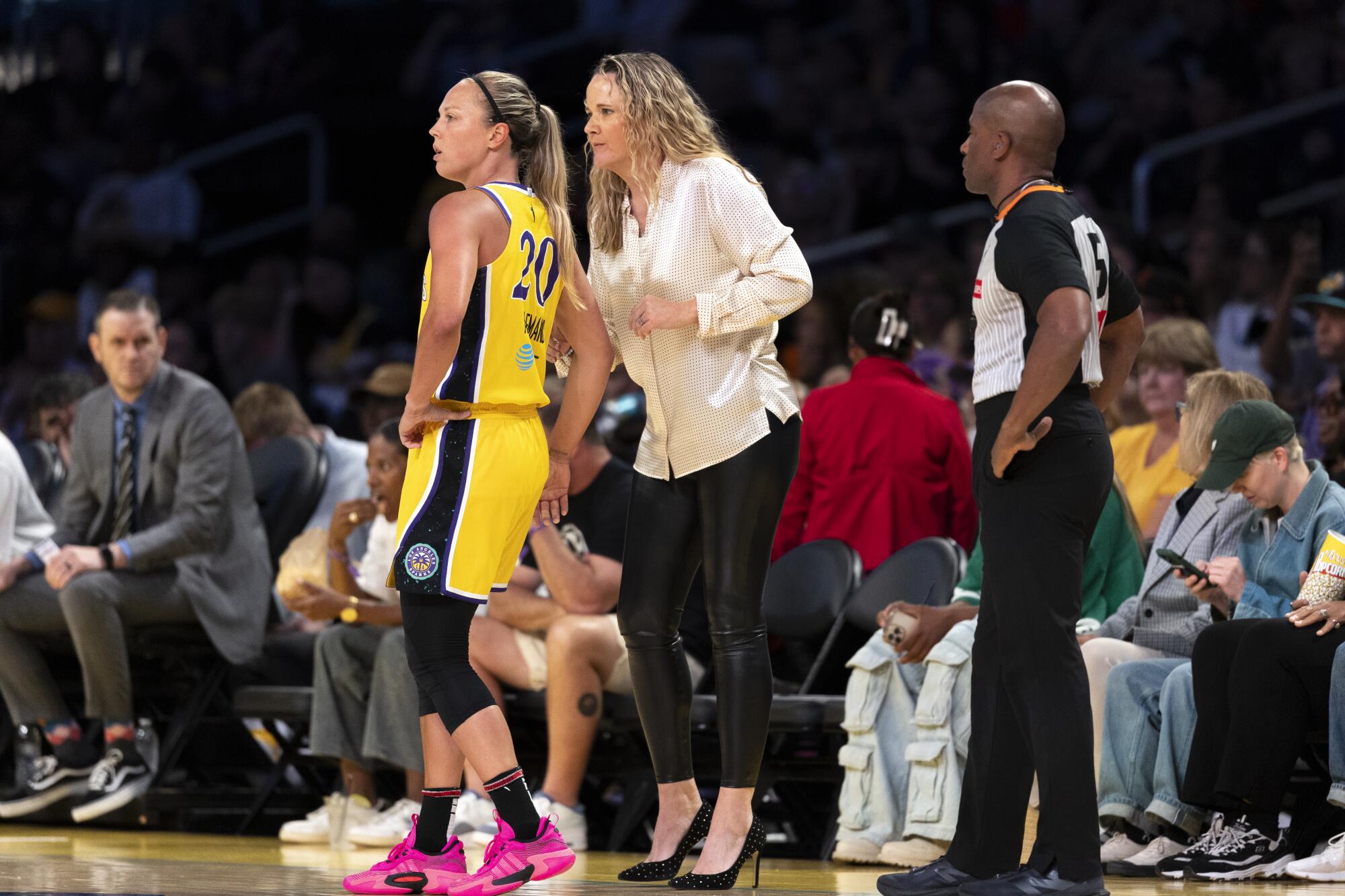Sparks coach Lynne Roberts, right, talks with guard Julie Allemand along the sideline during a break in play.