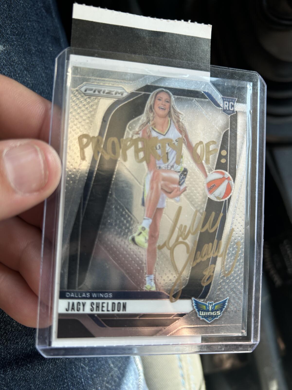 A Jacy Sheldon sports card inscribed 'Property of: Sophie Cunningham' in a clear plastic protective case