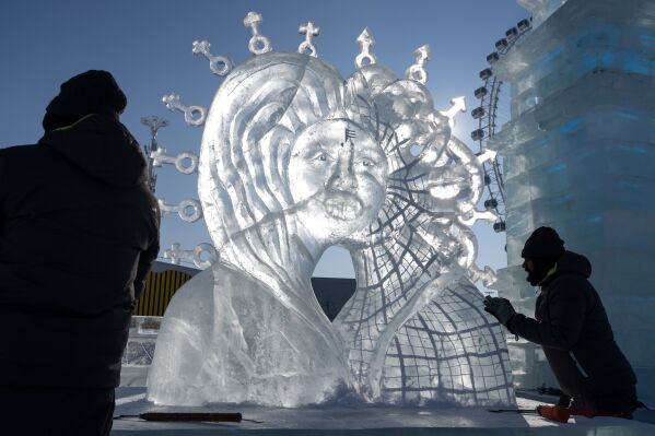 Competitors put the final touches on their piece for the ice sculpture competition at the annual Ice and Snow Festival held in Harbin in China's Heilongjiang province on Sunday, Jan. 4, 2026. (AP Photo/Ng Han Guan)