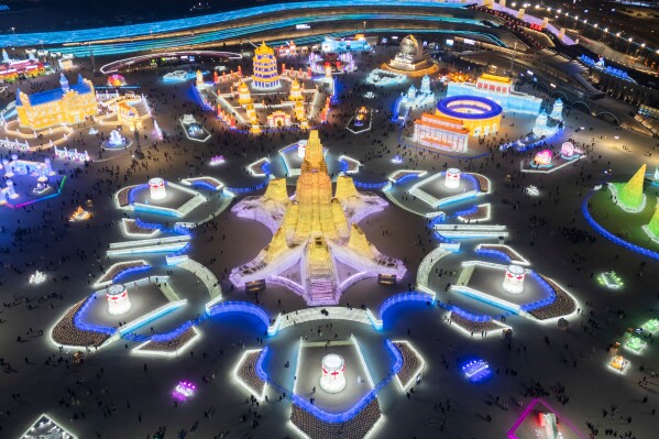 Attendees take in the sights at the annual Ice and Snow Festival held in Harbin in northeastern China's Heilongjiang province, Saturday, Jan. 3, 2026. (AP Photo/Ng Han Guan)