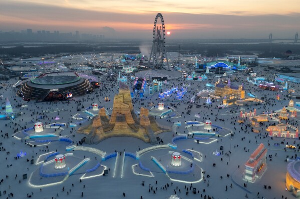 Attendees take in the sights at the annual Ice and Snow Festival held in Harbin in northeastern China's Heilongjiang province, Saturday, Jan. 3, 2026. (AP Photo/Ng Han Guan)