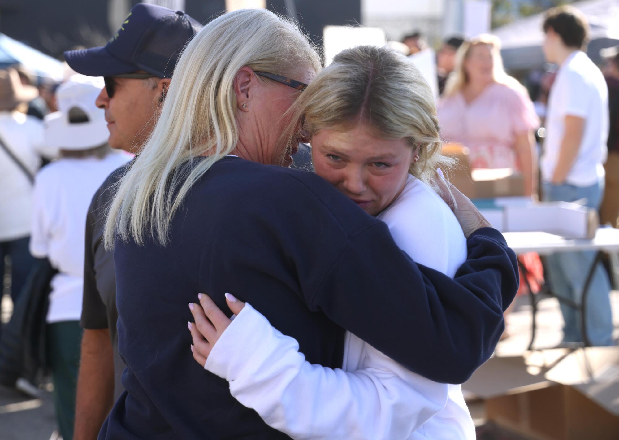 Pacific Palisades residents Julia Citron, right, cries with her mother Lainie with Palisades fire survivors.
