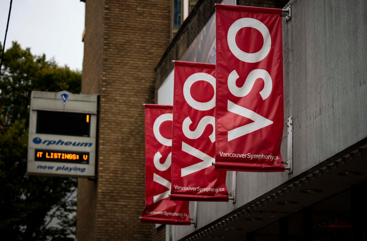 A number of red banners outside a building reading 'VSO'.