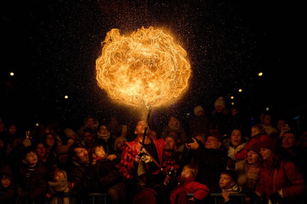 A fire eater performs during the traditional "Cabalgata de Reyes" parade in Madrid, Spain, Monday, Jan. 5, 2026, as part of the festivities marking the Catholic feast of Epiphany. (AP Photo/Bernat Armangue, File)