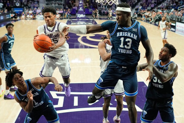 Kansas State forward Taj Manning, center left, beats BYU forward Keba Keita (13, File) to a rebound during the second half of an NCAA college basketball game Saturday, Jan. 3, 2026, in Manhattan, Kan. (AP Photo/Charlie Riedel, File)