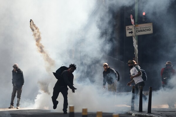 Members of the Bolivian Workers' Union clash with police during a protest against fuel subsidy cuts in El Alto, Bolivia, Monday, Jan. 5, 2026. (AP Photo/Freddy Barragan, File)