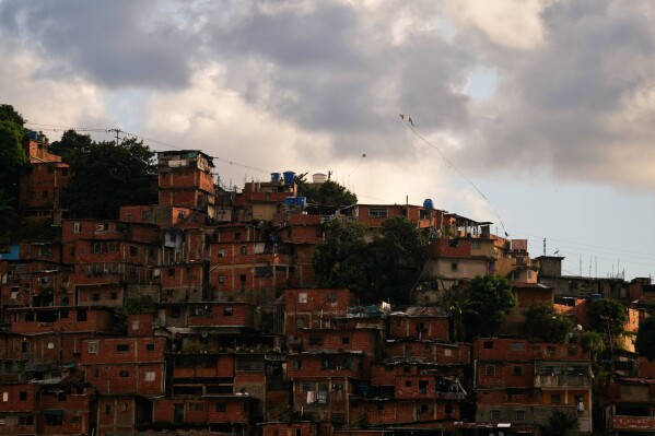 A kite flies over the Petare neighborhood of Caracas, Venezuela, Wednesday, Jan. 7, 2026. (AP Photo/Matias Delacroix)