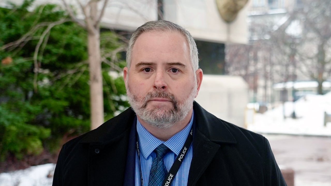 A man stands outside a building.
