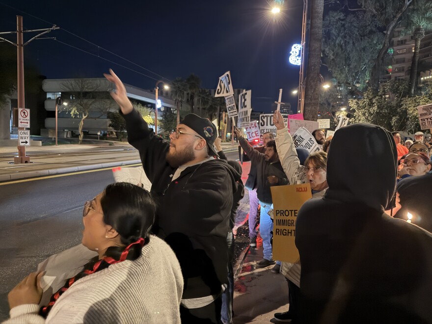 Protesters wave at honk cars driving on Central Avenue in Phoenix