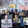 Minneapolis Public Schools families, educators and students hold signs during a press conference demanding Immigration and Customs Enforcement be kept out of schools and Minnesota on Friday, Jan. 9, 2026, at Lake Hiawatha Park in Minneapolis.
